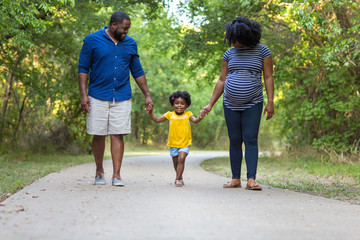 Portrait of a pregnant African American family. - Powered by Adobe