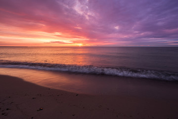 Fototapeta na wymiar bright, fire sunset on the sea beach