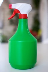 Green  sprayer bottle with nice soft background.