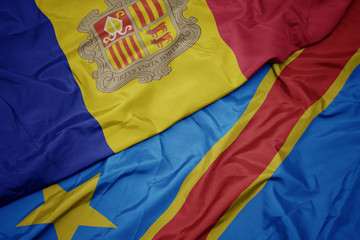 waving colorful flag of democratic republic of the congo and national flag of andorra.