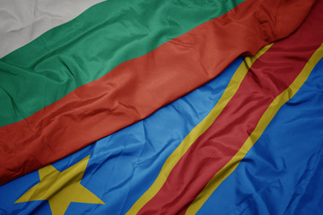 waving colorful flag of democratic republic of the congo and national flag of bulgaria.