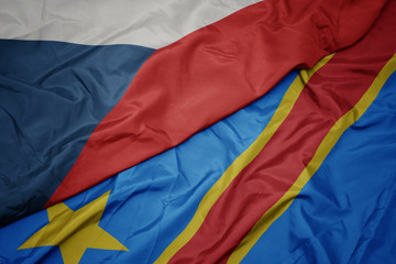 waving colorful flag of democratic republic of the congo and national flag of czech republic.