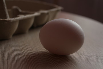 Chicken egg lies on the edge of the table