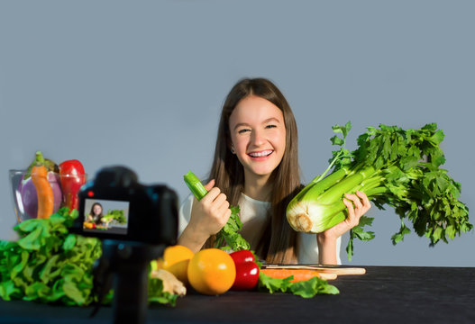 Teenage blogger talks to followers about the advantages of eating organic fruit and vegetables. Concept of communication to adolescents by a young influenzer of the benefits on well-being due to healt