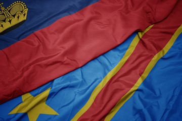 waving colorful flag of democratic republic of the congo and national flag of liechtenstein.