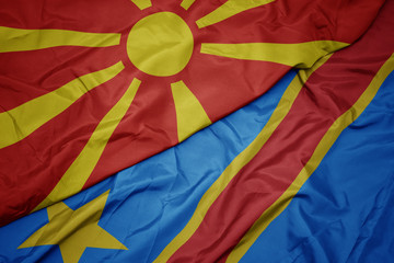 waving colorful flag of democratic republic of the congo and national flag of macedonia.