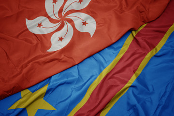 waving colorful flag of democratic republic of the congo and national flag of hong kong.