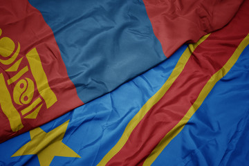 waving colorful flag of democratic republic of the congo and national flag of mongolia.