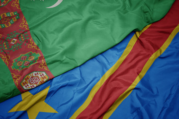 waving colorful flag of democratic republic of the congo and national flag of turkmenistan.
