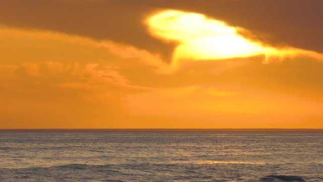 Caspian Sea at sunset. Waves run onto a rocky shore.