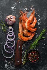 Grilled shrimps with sauce on a plate. Top view. Free copy space.