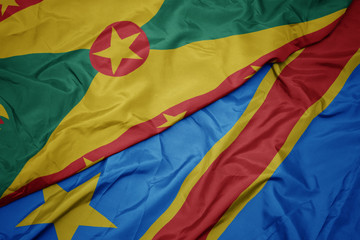 waving colorful flag of democratic republic of the congo and national flag of grenada.
