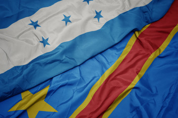 waving colorful flag of democratic republic of the congo and national flag of honduras.