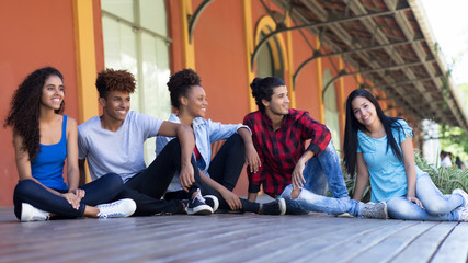 Group of relaxing hispanic and african american young adults