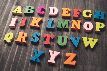 Wooden alphabet letters on wooden background