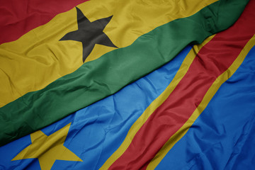 waving colorful flag of democratic republic of the congo and national flag of ghana.