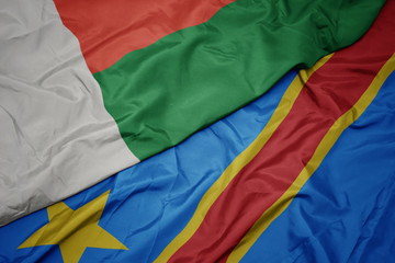 waving colorful flag of democratic republic of the congo and national flag of madagascar.
