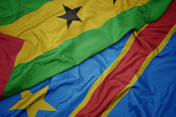 waving colorful flag of democratic republic of the congo and national flag of sao tome and principe .