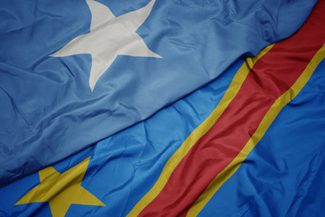 waving colorful flag of democratic republic of the congo and national flag of somalia.