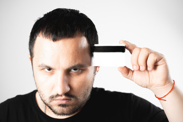 A man not developed fits an empty credit card to his temple, the concept of thinking about credit