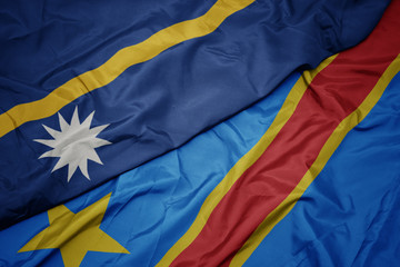 waving colorful flag of democratic republic of the congo and national flag of Nauru .