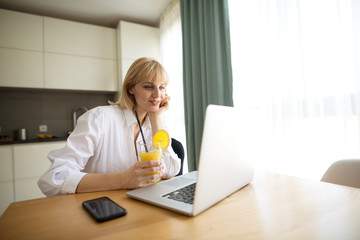 Beautiful pregnant business woman and smiling while sitting the working place at home