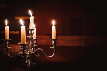 candles burning with red background light