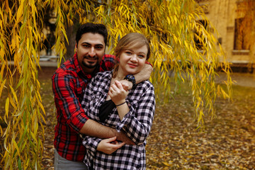 Loving couple in plaid shirts.