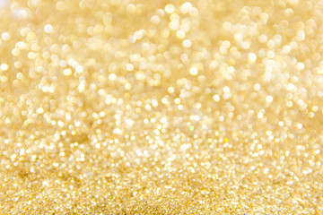 Defocused gold glitter background. Gold abstract bokeh background. Christmas abstract background.