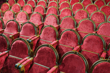 Empty vintage red wooden and velvet chairs