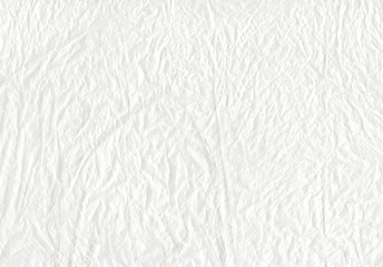 Fototapeta na wymiar white abstract texture background - closeup view of crumpled transparent plastic