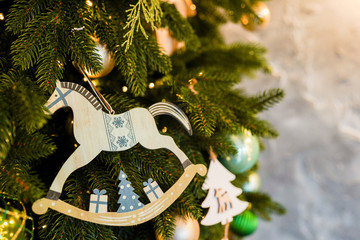 christmas toy wood horse on fir branch , scandinavian decoration