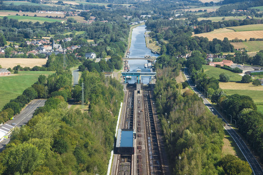 Belgium - Wallonia - Braine-le-Comte - The aerial panoramic view of downstream of Ronquieres inclined plane with one of its caissons mounted on rails full of water and surrounding fields and villages