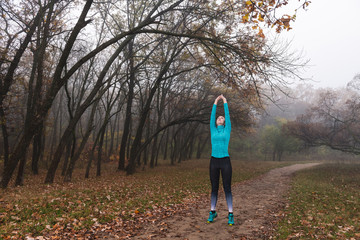 Woman stay on tips toes, hands up