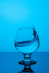 splash of water in a  blue glass