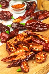 Slicing extra hot chili peppers (Bhut Jolokia Chocolate). Preparation for drying. Sale of hot spices. Healthy spices.