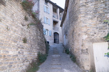 Fototapeta na wymiar gordes stones stairs in alley village in Luberon France South