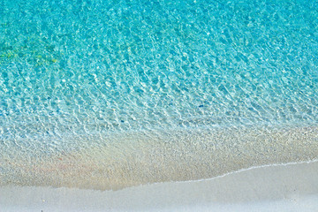 Fototapeta na wymiar Turquoise sea waves and white sand beach, Mediterranean sea. Aerial view.