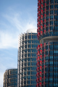 Three Modern red, blue and gray skyscrapers in a row at Barangaroo Sydney Australia with a blue sky