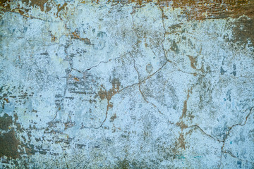 Wall fragment with attritions and cracks. Old paint peeling from wall texture background. Grunge wall white gray background texture.