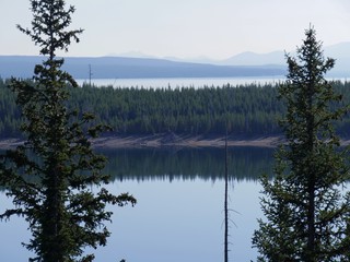 Breathtaking view of Yellowstone Lake frame by pine trees. Yellowstone National Park, Wyoming.