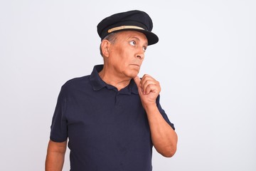 Senior grey-haired man wearing black polo and captain hat over isolated white background with hand on chin thinking about question, pensive expression. Smiling with thoughtful face. Doubt concept.