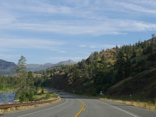 Cody, Wyoming, USA--July 2018: Scenic winding road at the North Fork Highway with the north Fork Soshone River flowing along the road.