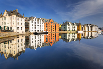 Fototapeta na wymiar Colorful architecture of Alesund reflected in the water, Norway