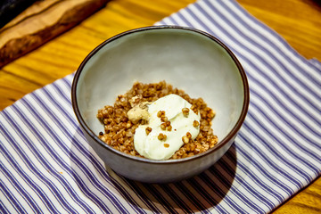 Buckwheat porridge with mushrooms and sour cream is in the plate
