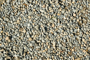 Abstract brown-gray background. Multi-colored and different-sized stone pebbles