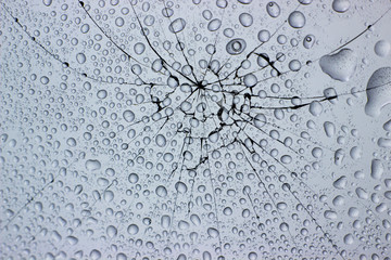 Dew drops on cracked broken window glass