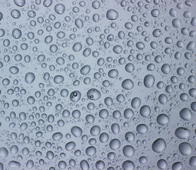 Drops of water on clear glass. Window background with dew.