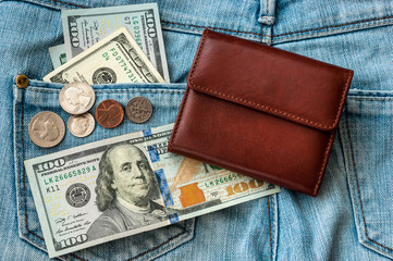purse money. on jeans background.