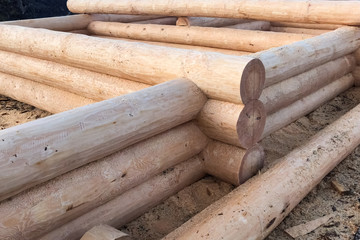 Drying and assembly of wooden log house at a construction base.